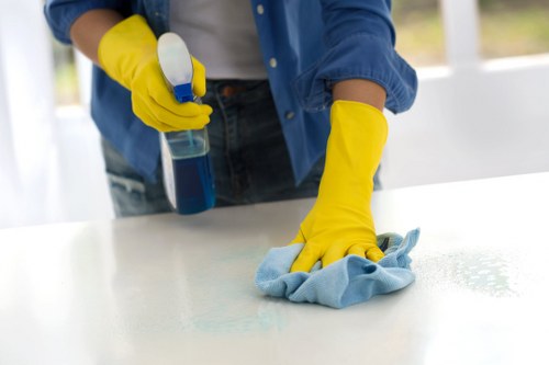 Janitorial staff disinfecting high-touch surfaces in a workplace